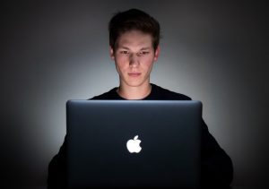 man using Mac laptop